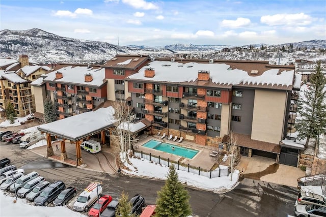 snowy aerial view featuring a mountain view