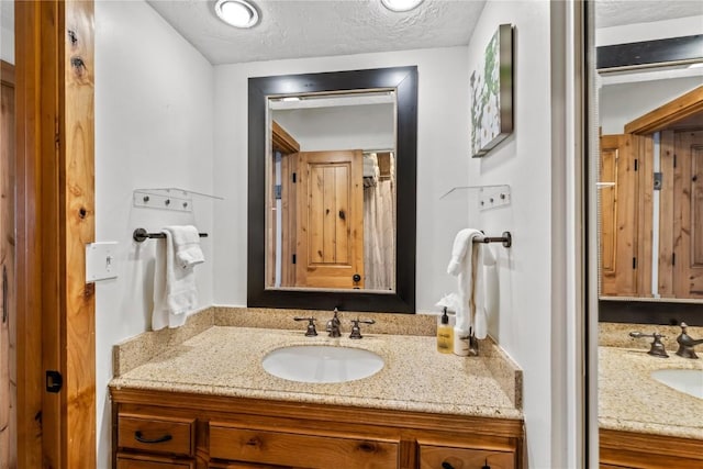 bathroom with vanity and a textured ceiling