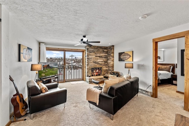 carpeted living room featuring ceiling fan, a fireplace, a textured ceiling, and baseboard heating