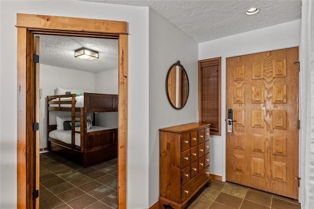 foyer entrance with a textured ceiling