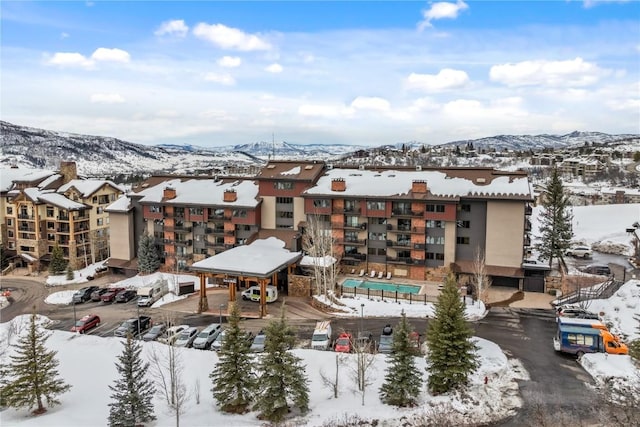 snowy aerial view featuring a mountain view