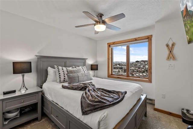 bedroom featuring dark colored carpet, ceiling fan, a textured ceiling, and a baseboard heating unit