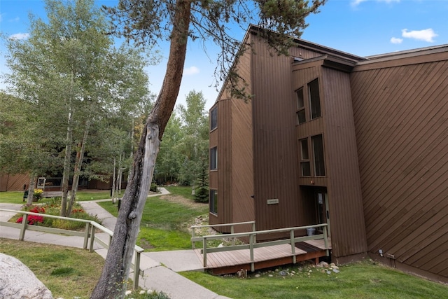 view of property's community featuring a yard and a deck