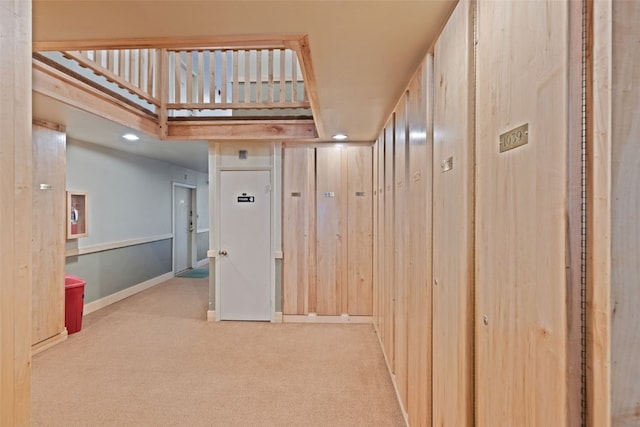 hall featuring light colored carpet