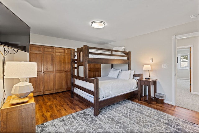 bedroom with a closet and dark hardwood / wood-style flooring