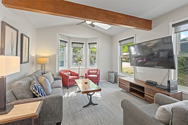 carpeted living room featuring a wealth of natural light, ceiling fan, and lofted ceiling with beams