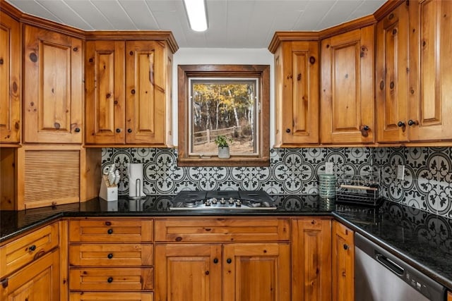 kitchen with tasteful backsplash, dark stone counters, and appliances with stainless steel finishes