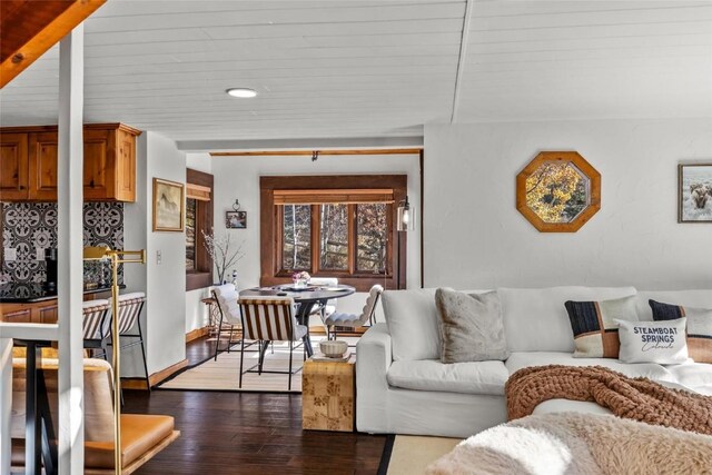 living room with dark wood-type flooring and wood ceiling