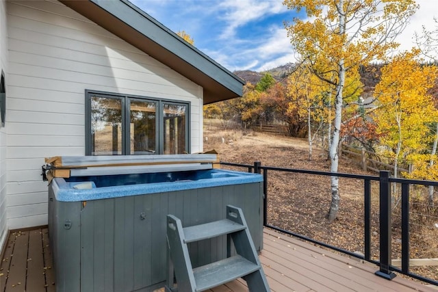 wooden deck featuring a hot tub