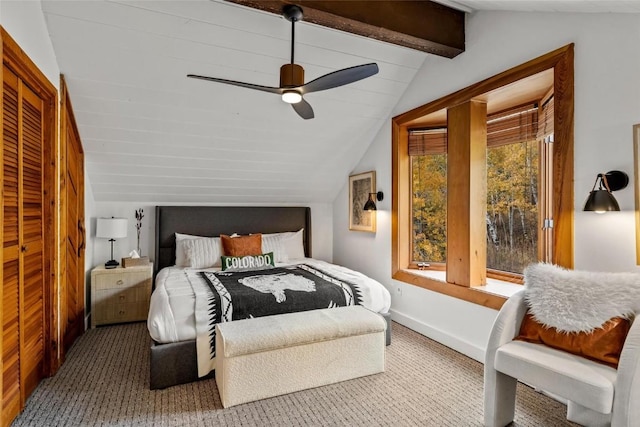 carpeted bedroom with vaulted ceiling with beams, ceiling fan, and multiple windows