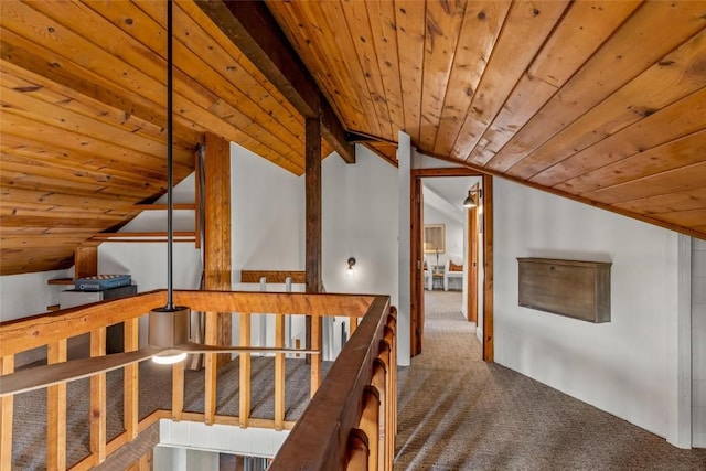 hallway with vaulted ceiling with beams, wood ceiling, and dark carpet