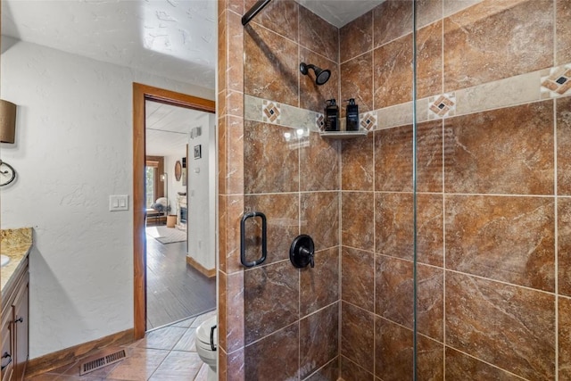 bathroom featuring vanity, toilet, and walk in shower