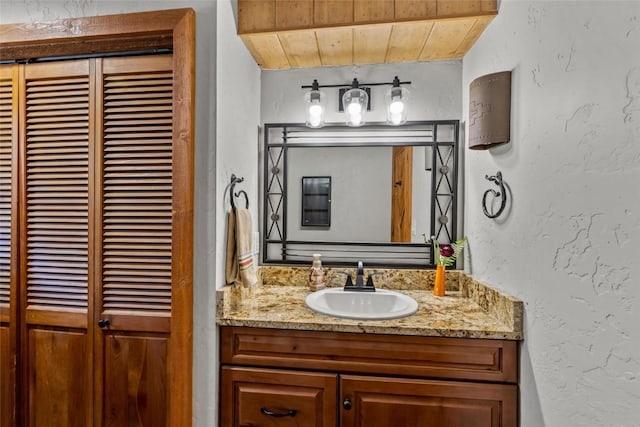 bathroom featuring vanity and wood ceiling