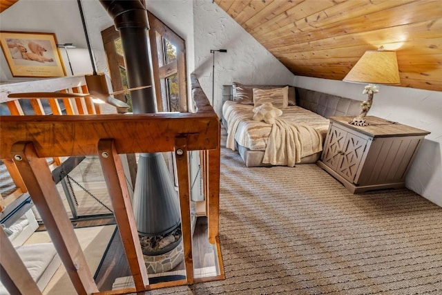 bedroom featuring lofted ceiling, wooden ceiling, and light carpet