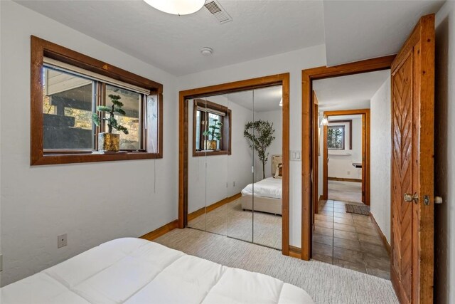 carpeted bedroom featuring a closet