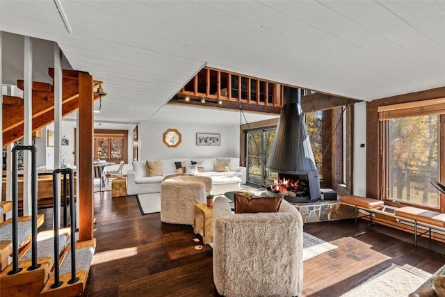 living room with dark hardwood / wood-style floors and a fireplace