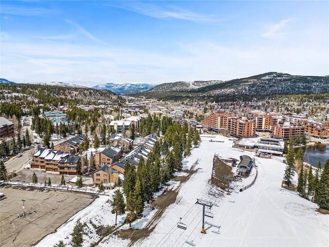 snowy aerial view featuring a mountain view