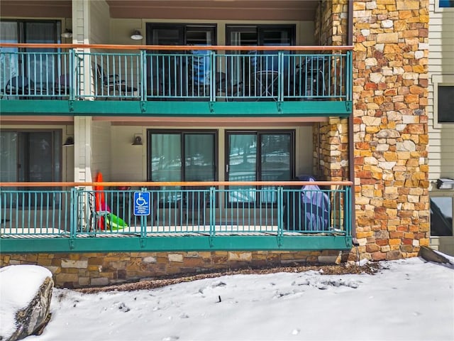 view of snow covered rear of property