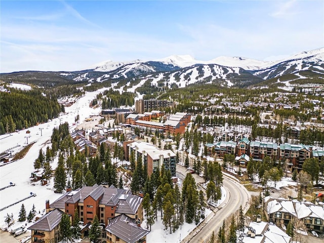 snowy aerial view featuring a mountain view