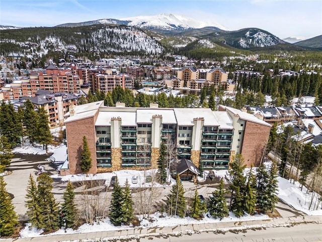 snowy aerial view featuring a mountain view