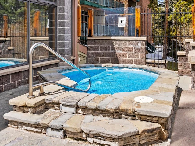 view of swimming pool featuring a community hot tub