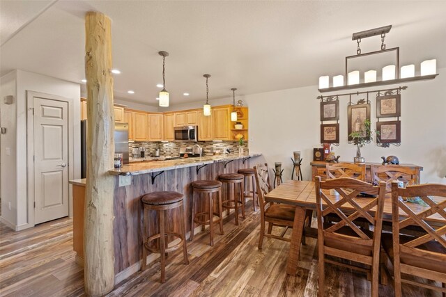 dining area with dark hardwood / wood-style floors