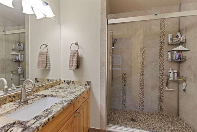 bathroom featuring vanity and an enclosed shower