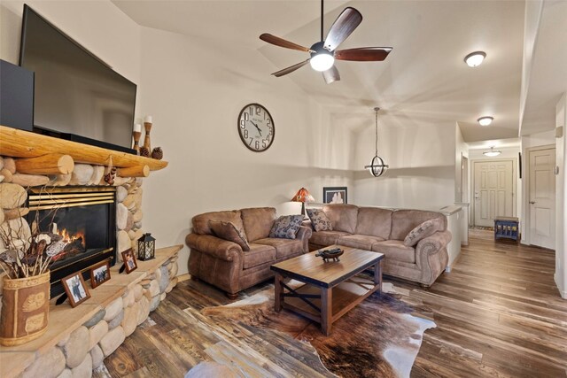 living room with vaulted ceiling, ceiling fan, a fireplace, and dark hardwood / wood-style floors