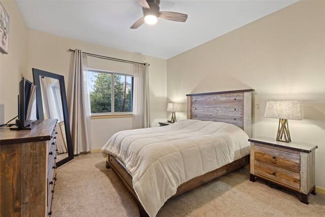 bedroom with ceiling fan and light colored carpet