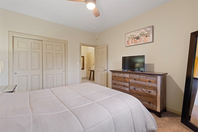 carpeted bedroom with a closet and ceiling fan