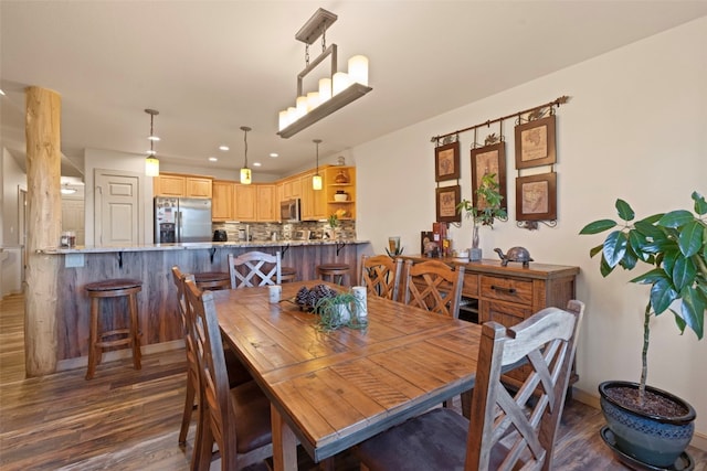 dining room with dark hardwood / wood-style floors