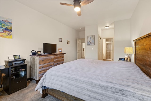 carpeted bedroom featuring connected bathroom and ceiling fan