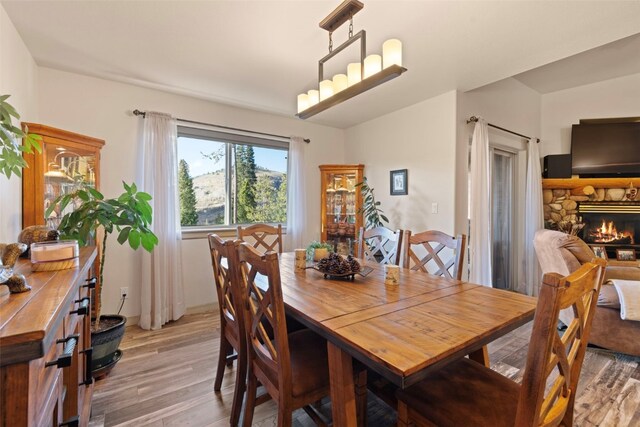 dining room featuring hardwood / wood-style floors and a fireplace