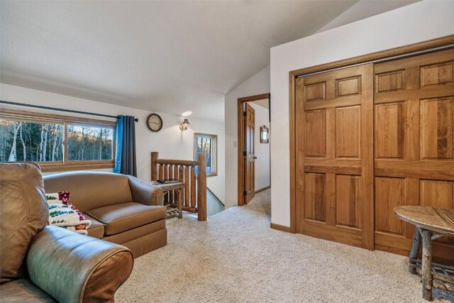 living room featuring light colored carpet and vaulted ceiling