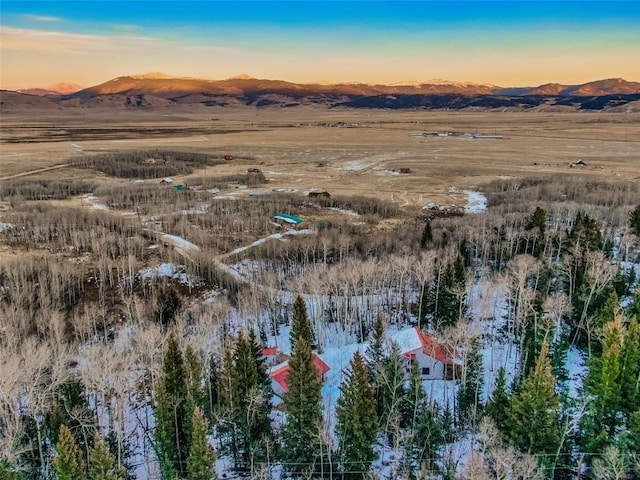 aerial view at dusk featuring a mountain view