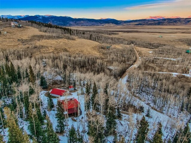 snowy aerial view with a mountain view