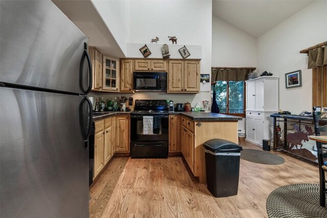 kitchen with kitchen peninsula, light brown cabinetry, black appliances, high vaulted ceiling, and light hardwood / wood-style flooring