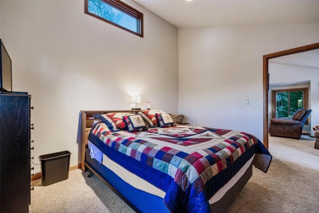 bedroom with carpet and lofted ceiling