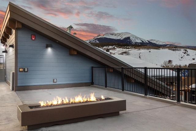 exterior space with a fire pit and a mountain view