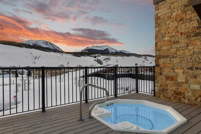 snow covered deck with a mountain view