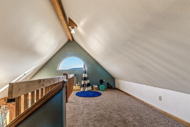 bedroom featuring lofted ceiling with beams, baseboards, and carpet