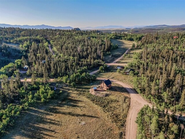 bird's eye view with a mountain view and a forest view