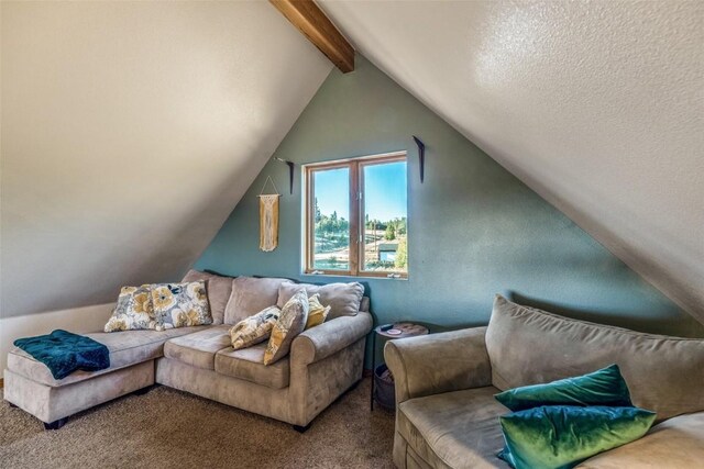 living area featuring vaulted ceiling with beams, carpet floors, and a textured ceiling