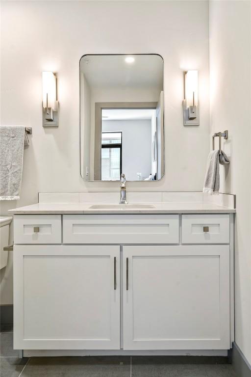 bathroom featuring tile patterned flooring and vanity