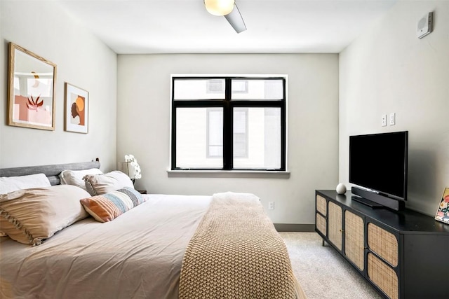 bedroom with ceiling fan and light colored carpet