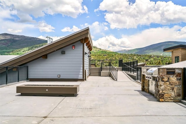 view of patio / terrace with a mountain view, area for grilling, and grilling area