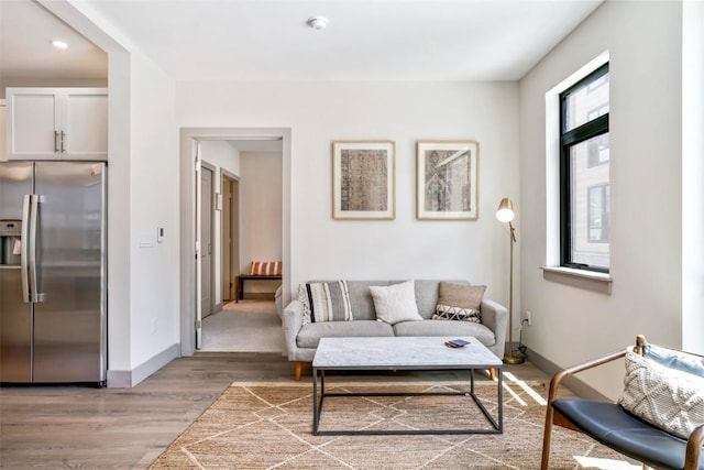 living room with a healthy amount of sunlight and light hardwood / wood-style floors