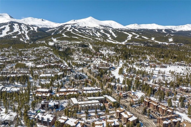 snowy aerial view with a mountain view