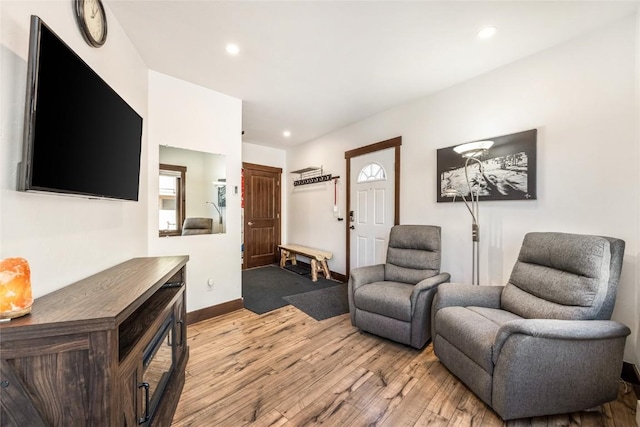 sitting room with recessed lighting, baseboards, and light wood-style floors