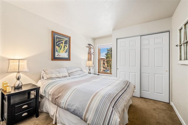 bedroom with a closet, baseboards, and carpet floors